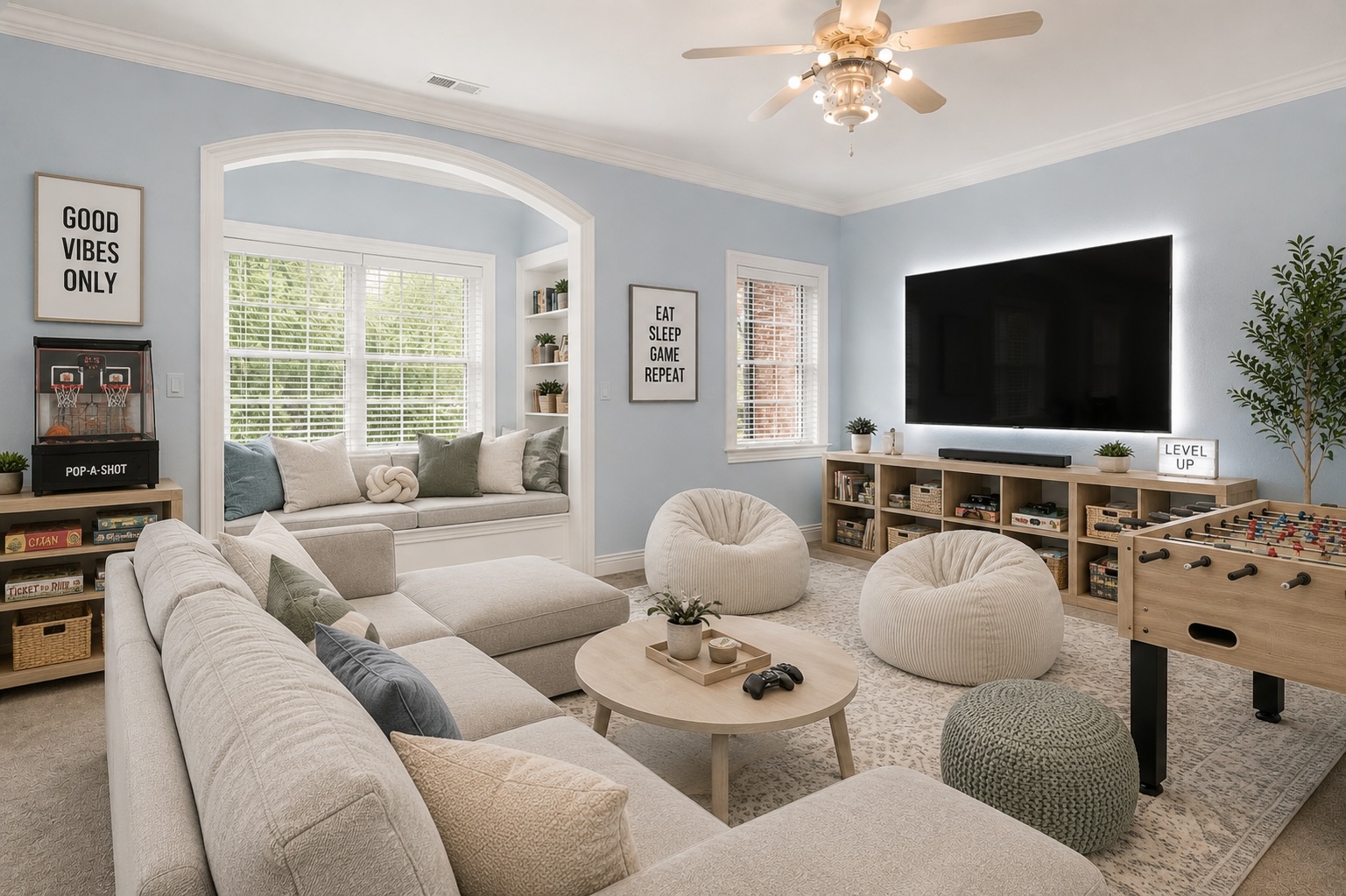 Reimagined rec room as a teen game lounge with sectional, foosball table, pop-a-shot, mounted TV, and bean bags